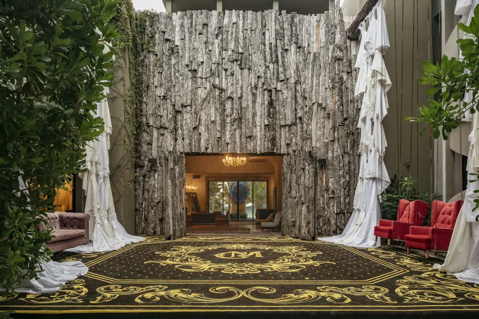 Dramatic carpeted entrance with draped fabric and seating at Casa Malca.