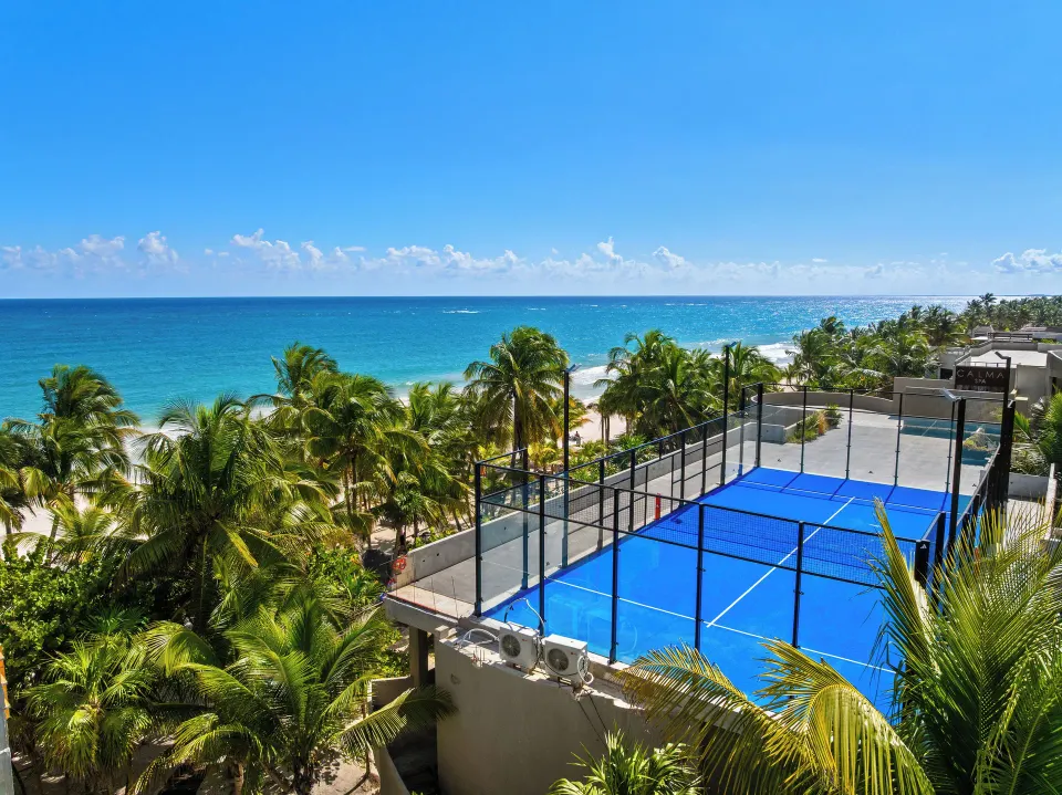 Blue rooftop paddle court overlooking the ocean at Casa Malca.