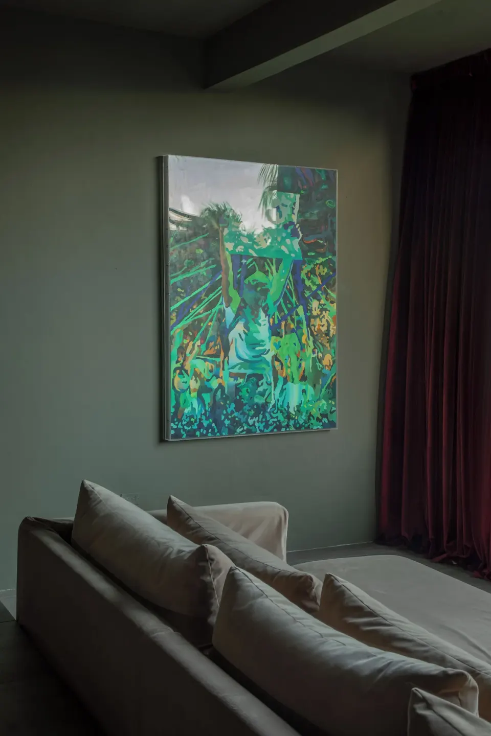 Artwork above sofa and deep red curtains in a junior suite at Casa Malca