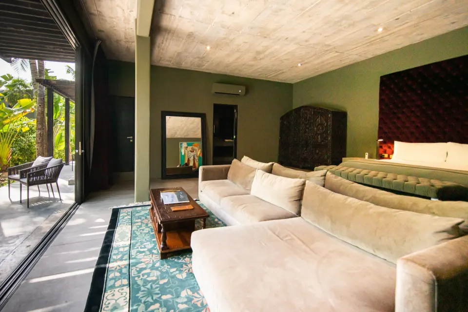 Junior Suite Garden View showing king bed, large sectional sofa and open terrace at Casa Malca