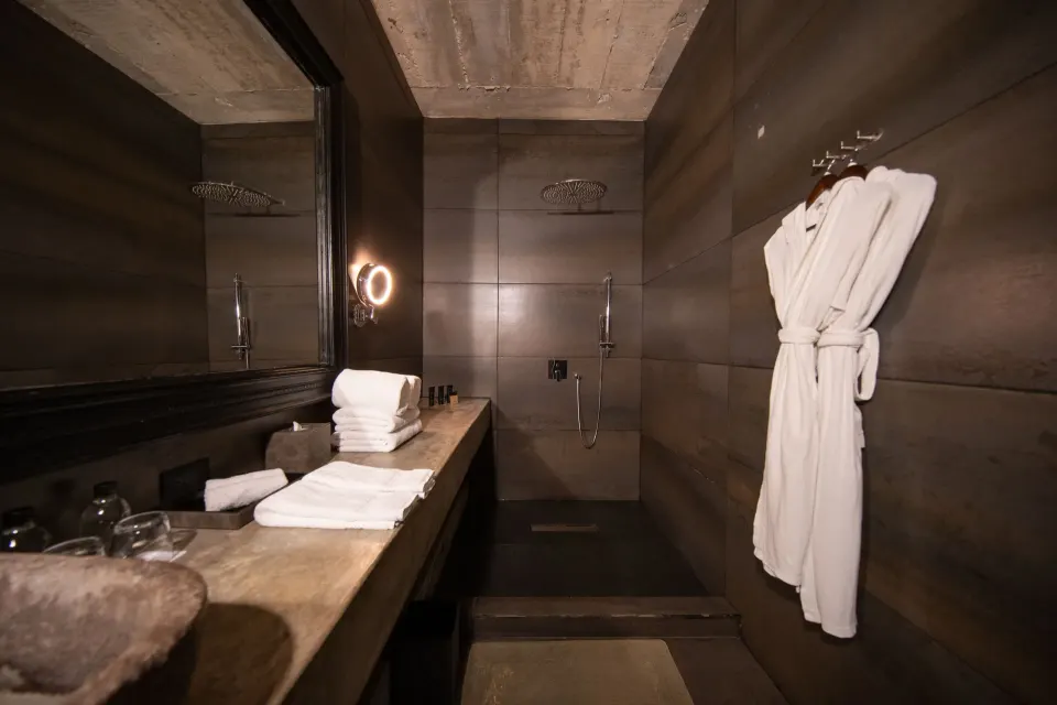Walk-in shower and bathrobe on hook in Junior Suite Garden View at Casa Malca