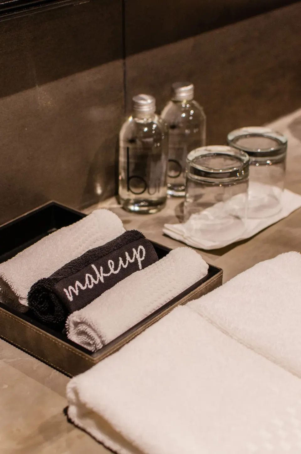 Vanity with towels and water bottles in a Junior Suite Garden View at Casa Malca