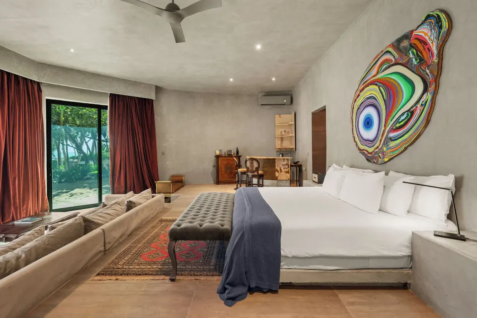 Spacious Beachfront Master suite with king bed and colorful wall art at Casa Malca