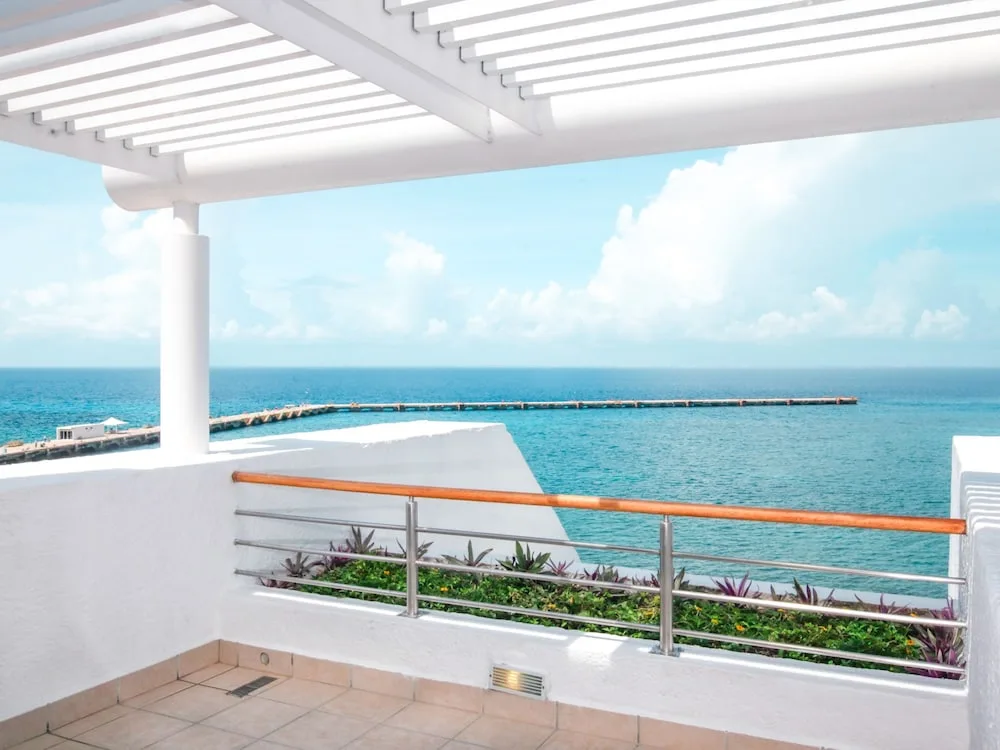 Balcony view over the sea with pergola and railing at Casa Mexicana Cozumel