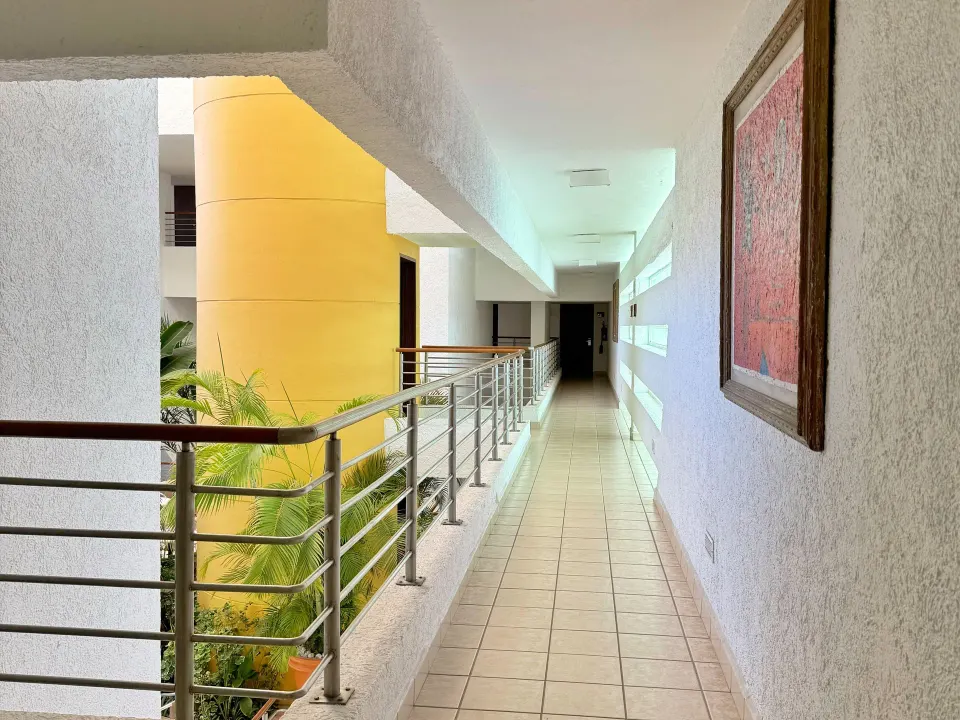 Second-floor interior corridor overlooking the atrium at Casa Mexicana Cozumel