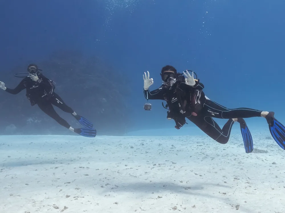 Two scuba divers exploring clear water off Cozumel near Casa Mexicana Cozumel.