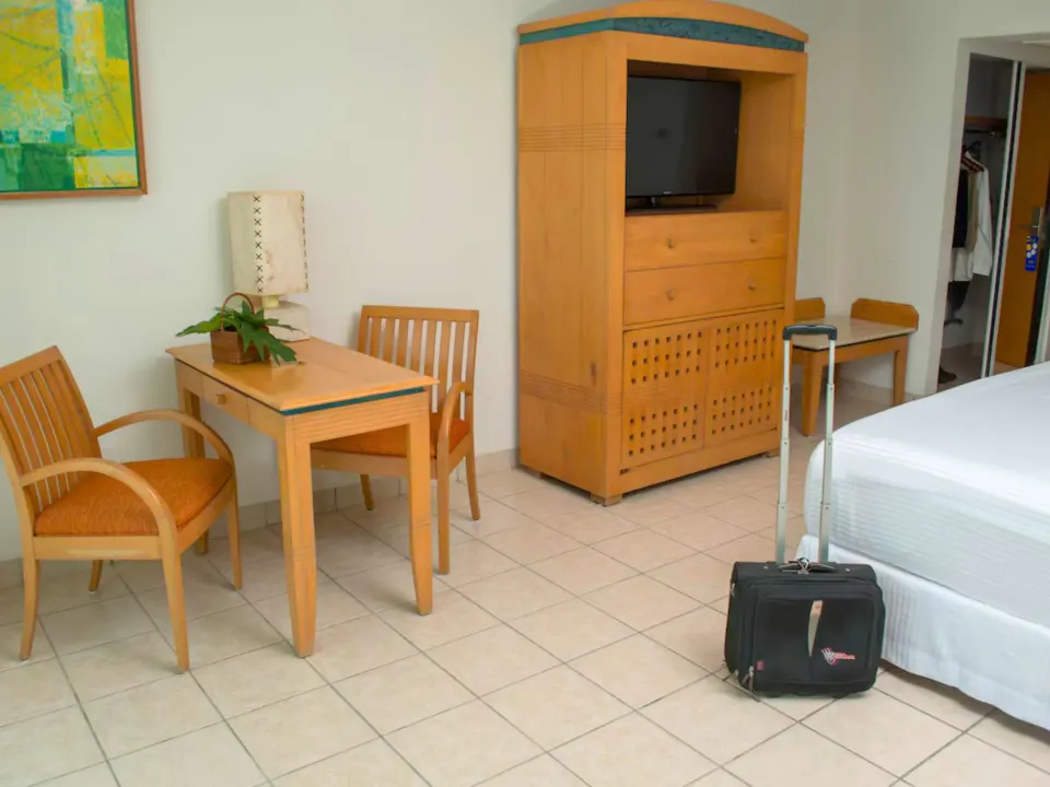 Work table, chairs and TV cabinet in a Habitacion Deluxe at Casa Mexicana Cozumel