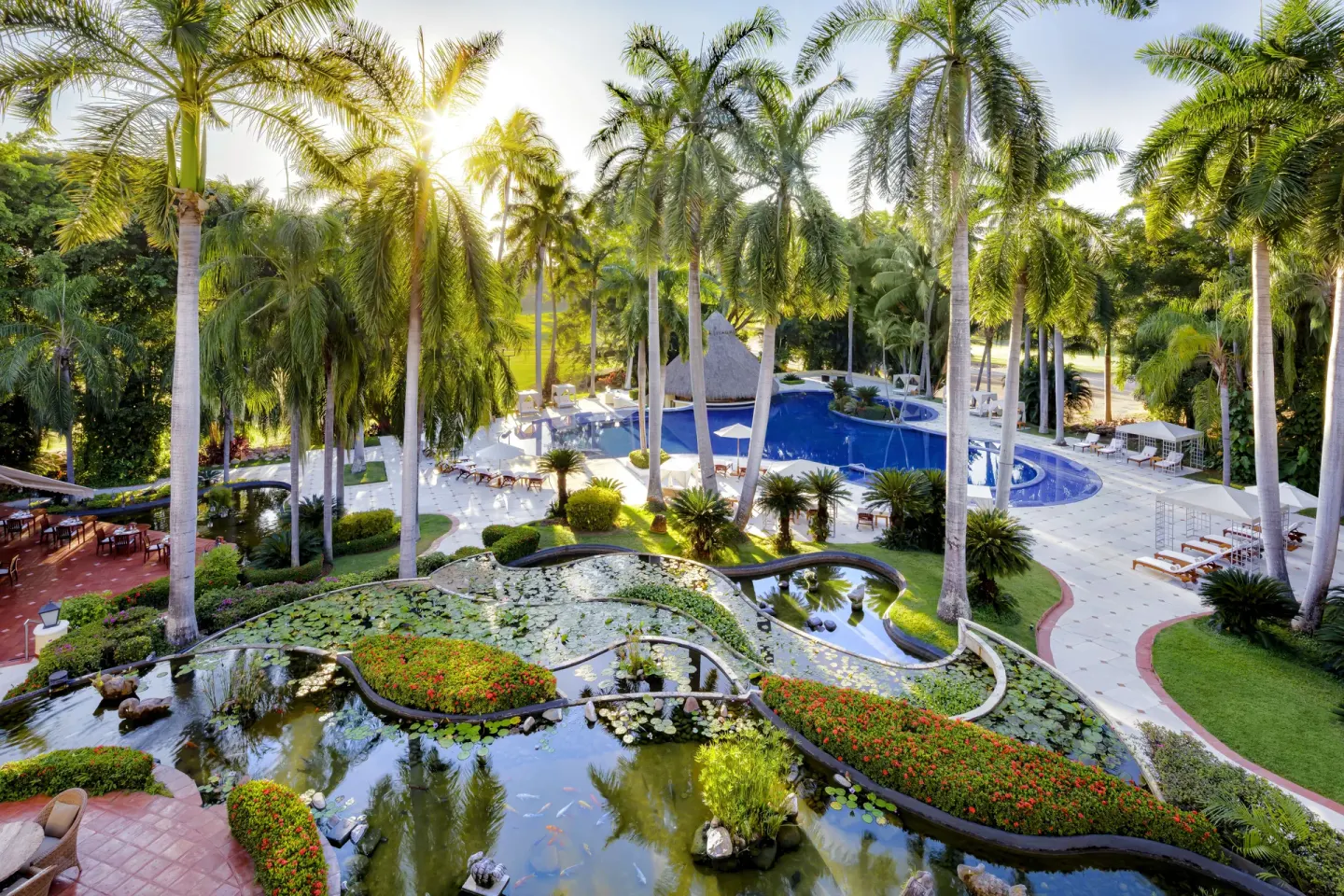 Aerial view of palm gardens, lily ponds, and the pool at Casa Velas.