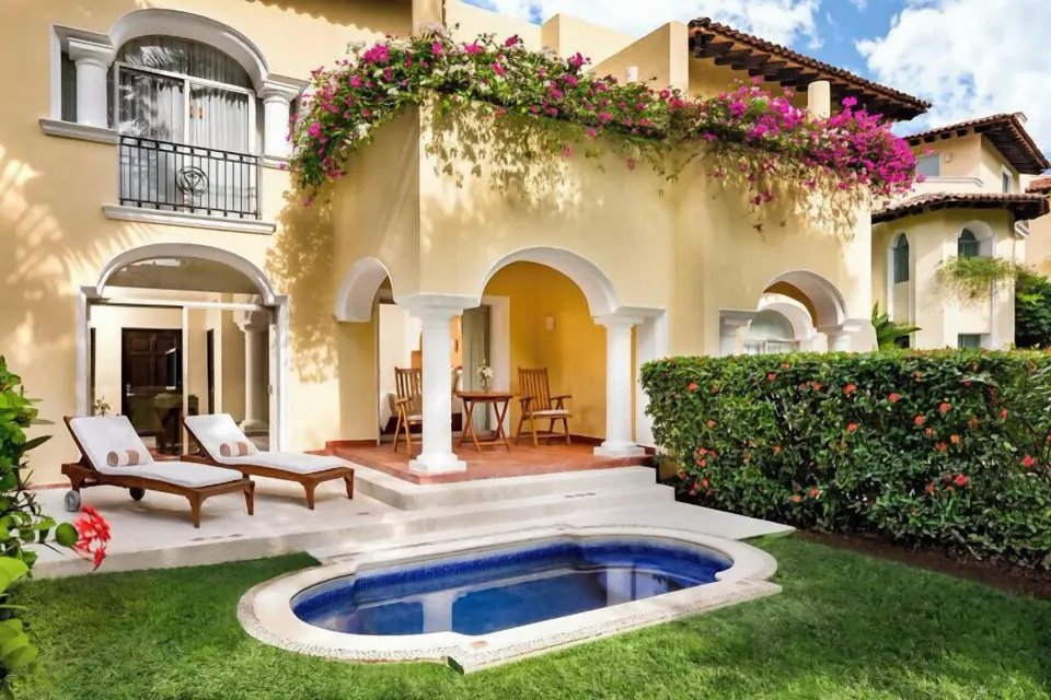 Grand Class Plus exterior with private plunge pool, loungers, and flowering balcony at Casa Velas.