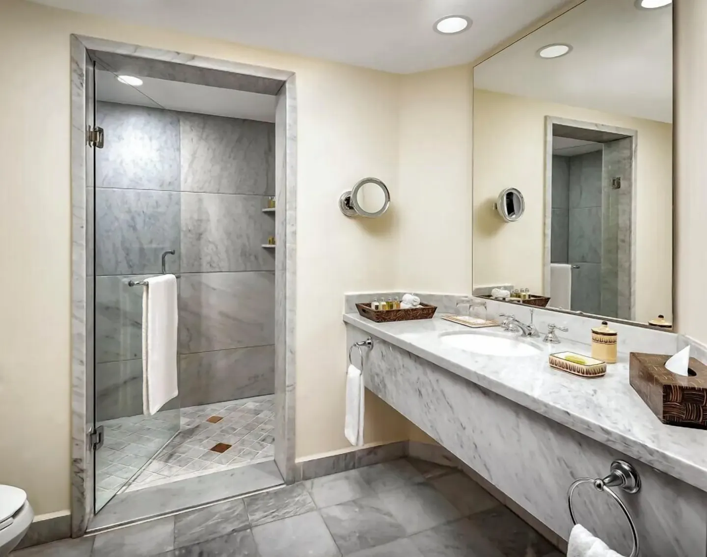 Grand Class Plus marble bathroom with vanity and glass shower at Casa Velas.