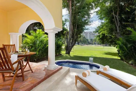 Grand Class Plus terrace with plunge pool, loungers, and garden view at Casa Velas.