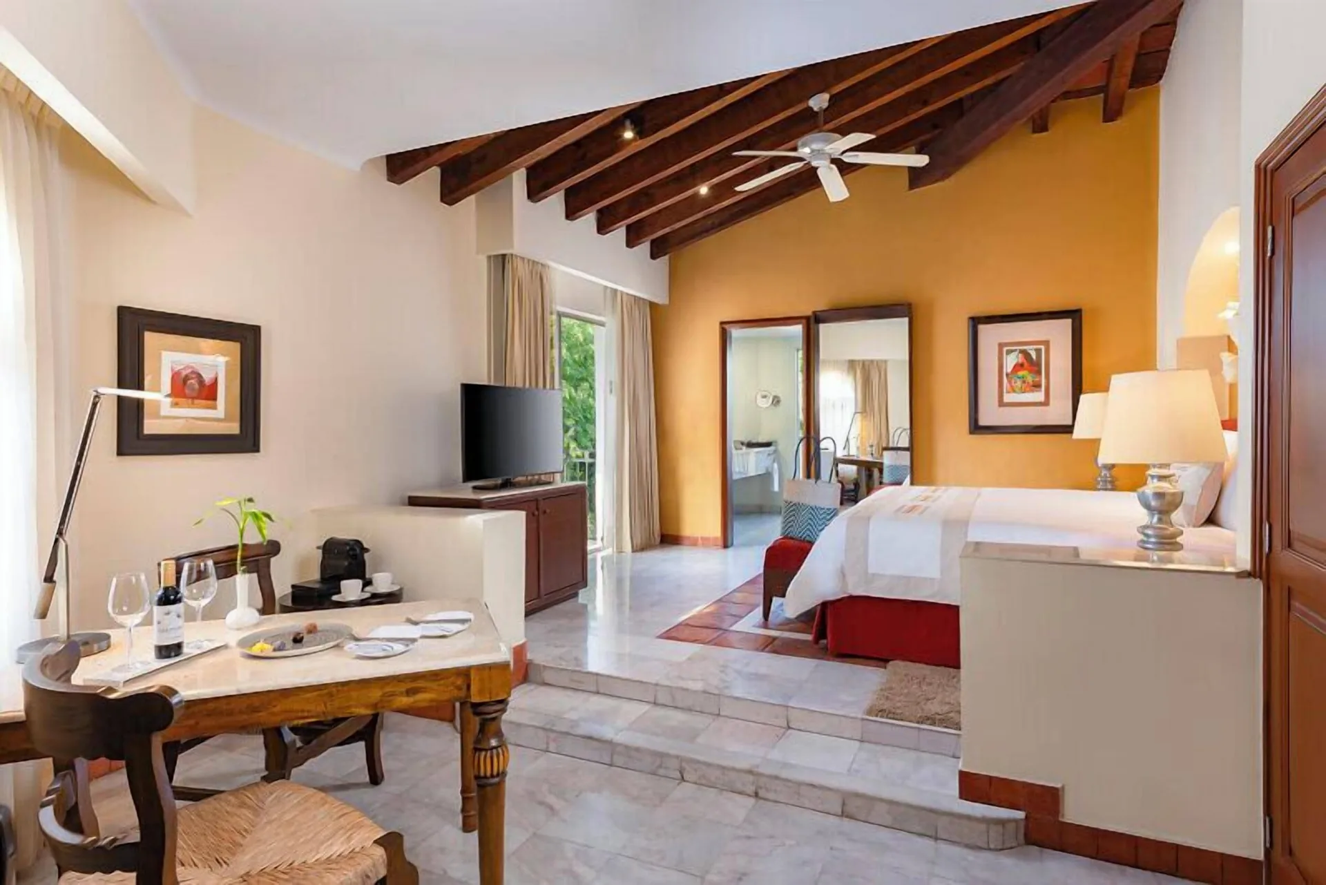 Master Suite Plus with raised king bed area and dining table at Casa Velas.