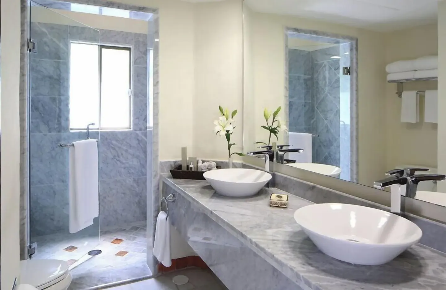 One Bedroom Ambassador Suite bathroom with double vessel sinks and glass shower at Casa Velas.