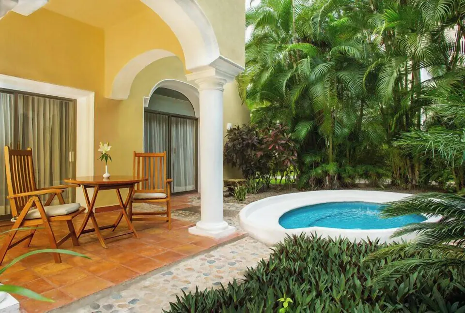 One Bedroom Ambassador Suite terrace with table, chairs, and plunge pool at Casa Velas.