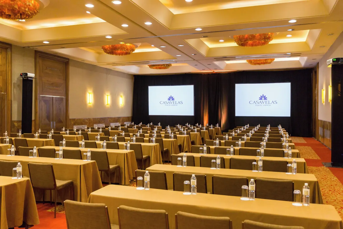 Conference room with classroom seating and projection screens at Casa Velas.