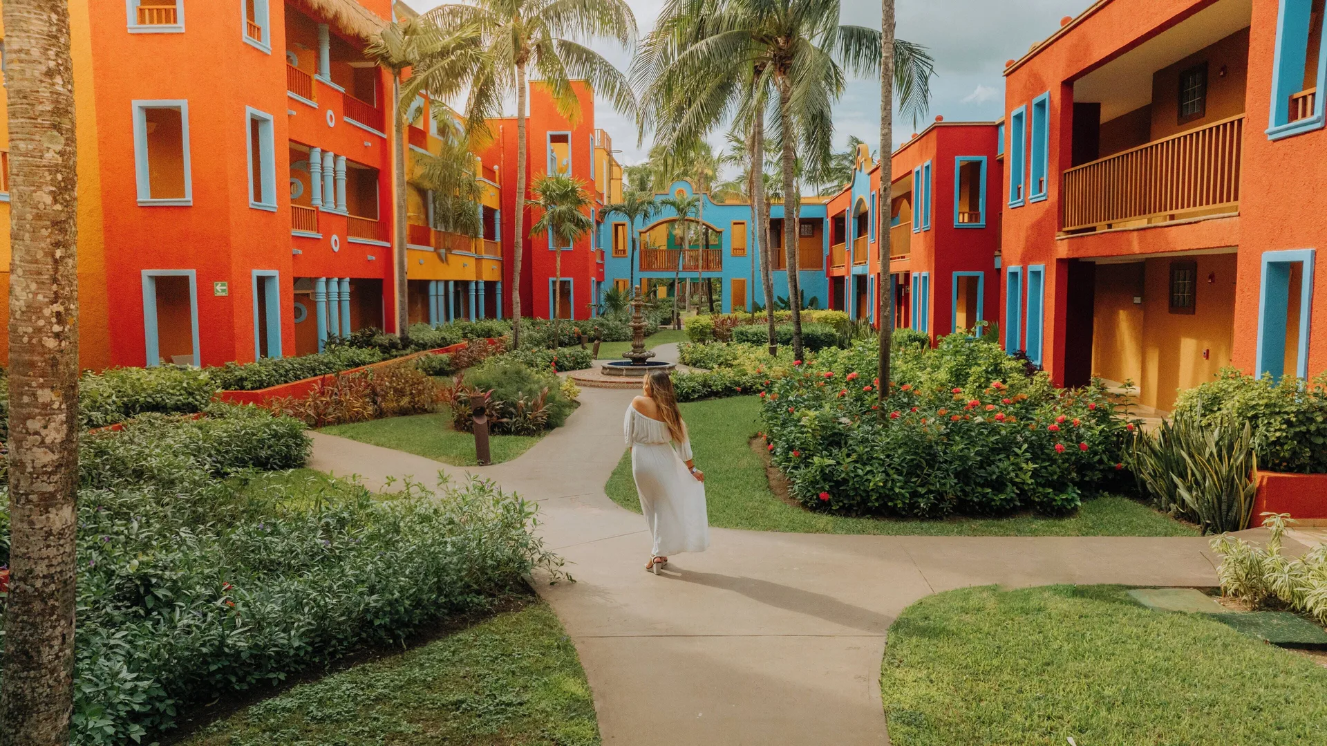 Colorful guest buildings and garden paths at Catalonia Playa Maroma.