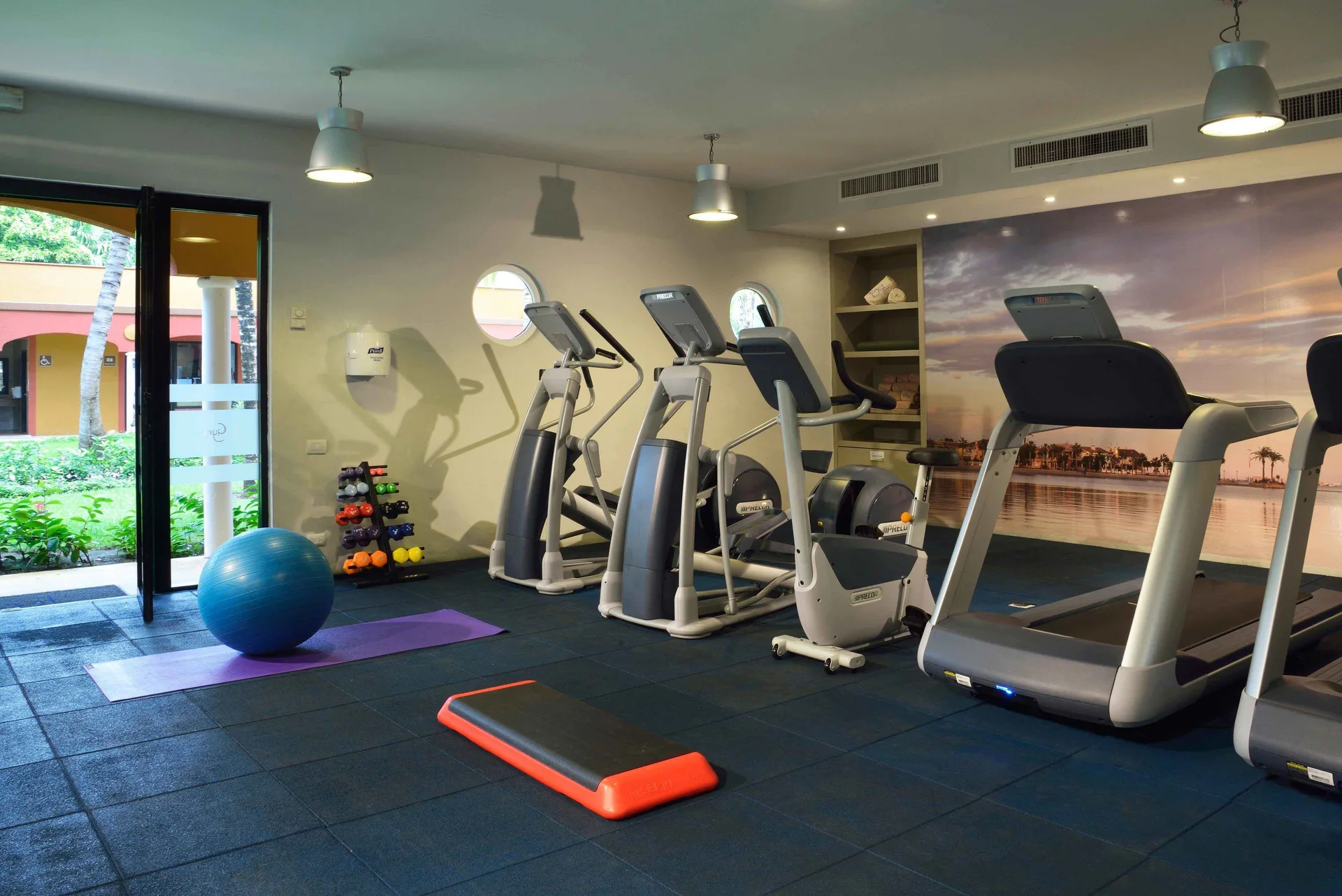 Fitness room with treadmills, cardio machines, and weights at Catalonia Playa Maroma.