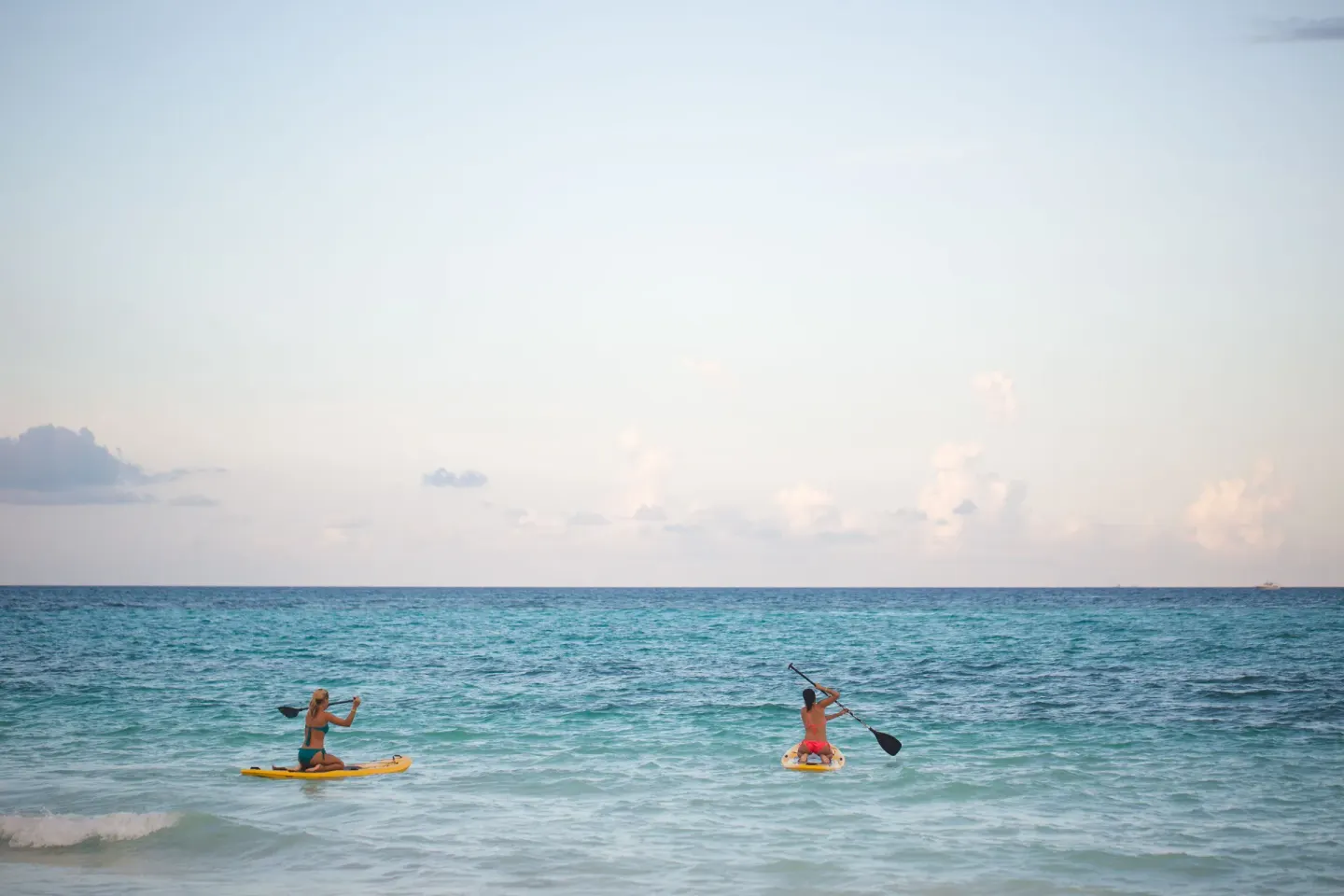 Two paddleboarders on turquoise water off Catalonia Playa Maroma.