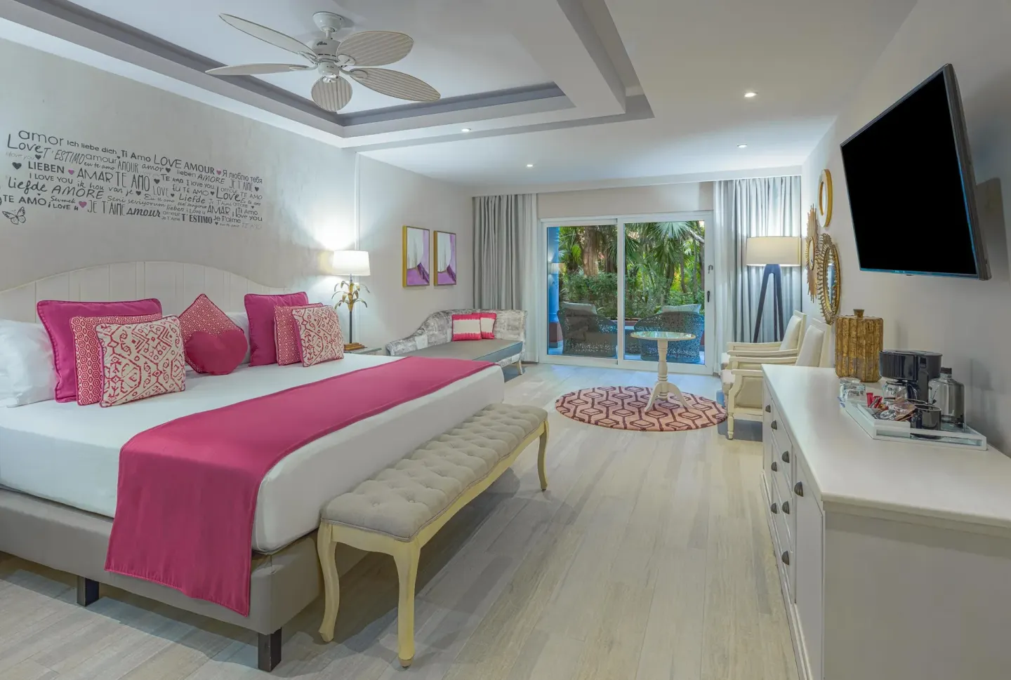 Romantic-style guest room with king bed and pink accents at Catalonia Playa Maroma.