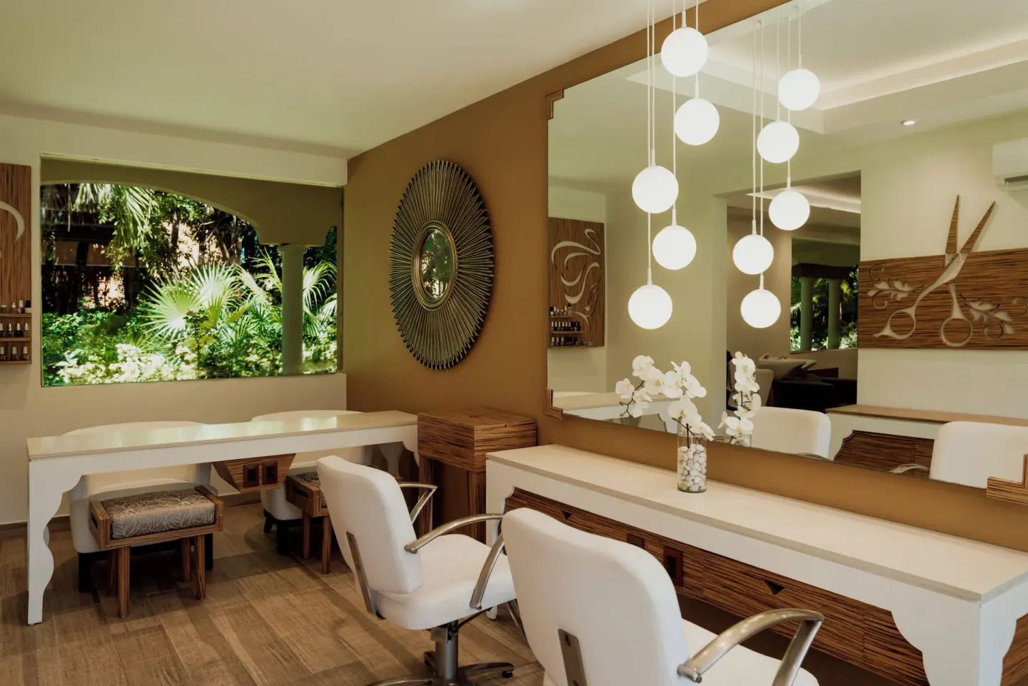 Bright salon styling stations with garden views at Catalonia Playa Maroma.