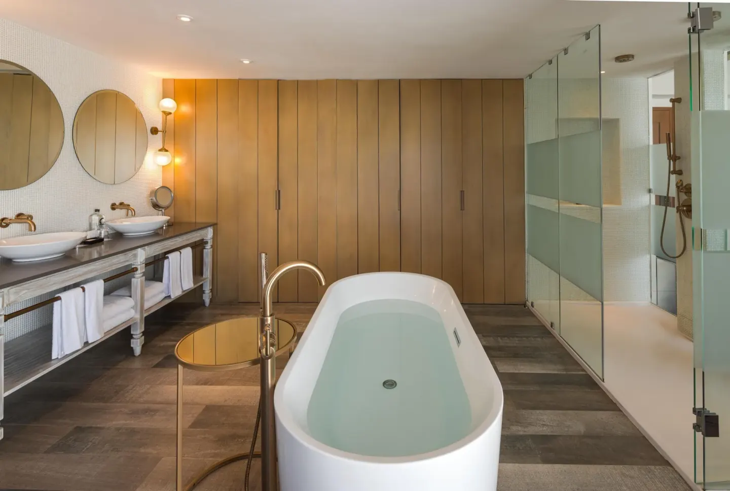 Spacious bathroom with soaking tub, double sinks, and glass shower at Catalonia Playa Maroma.