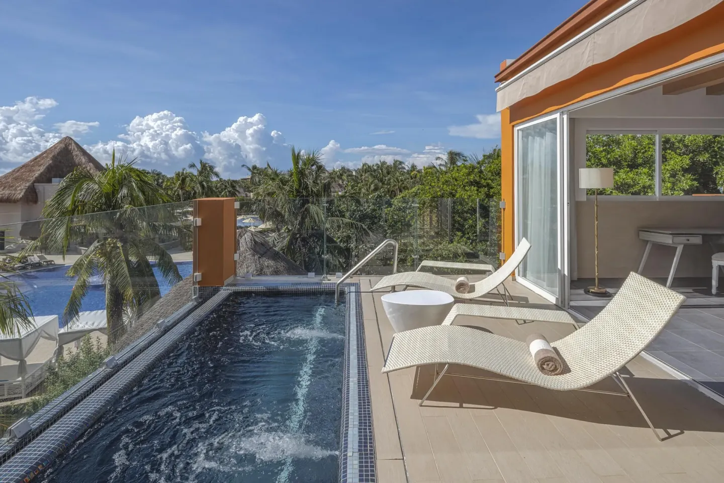 Suite terrace with plunge pool, loungers and palm views at Catalonia Playa Maroma.
