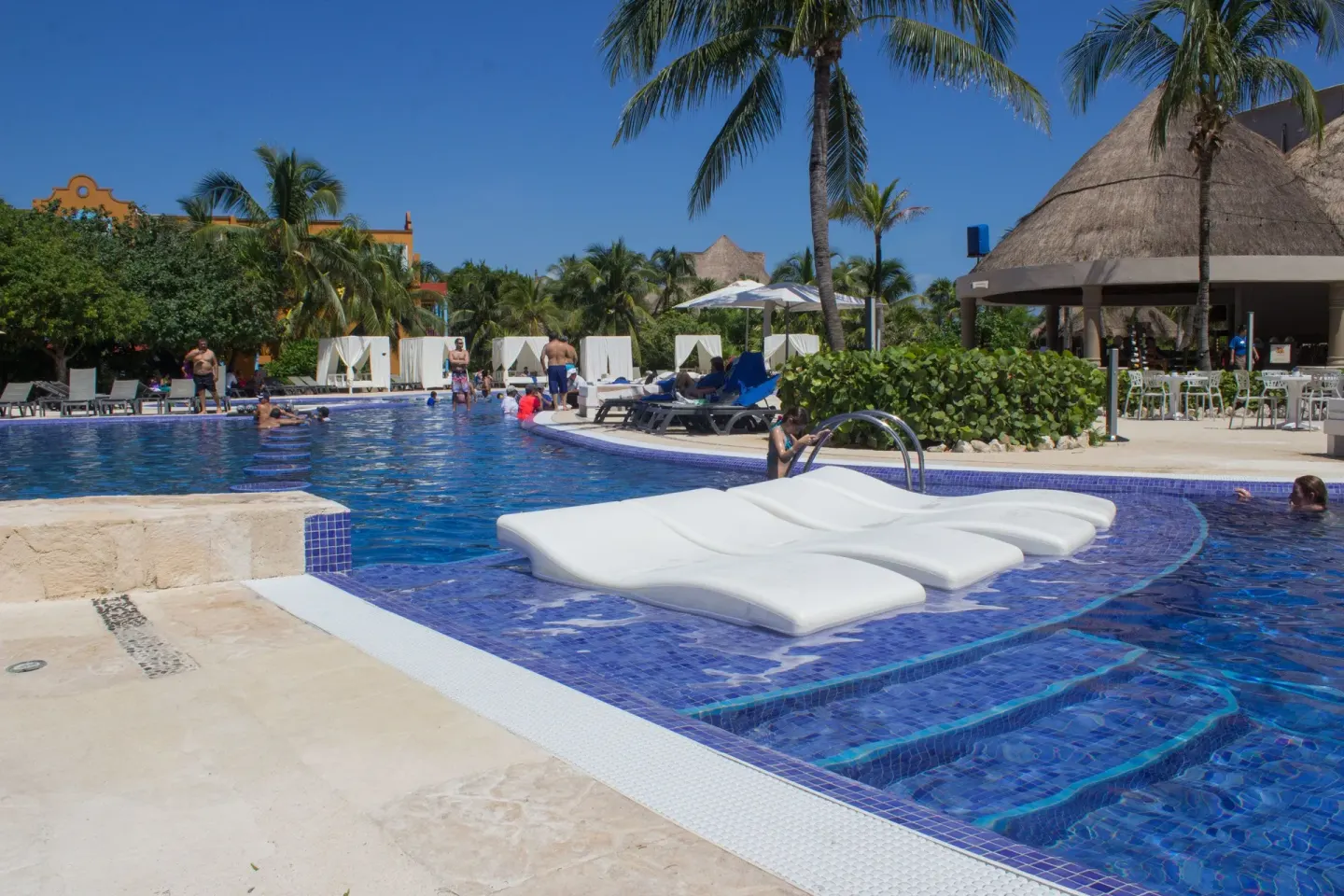 Swim-up pool area with in-water loungers at Catalonia Playa Maroma.
