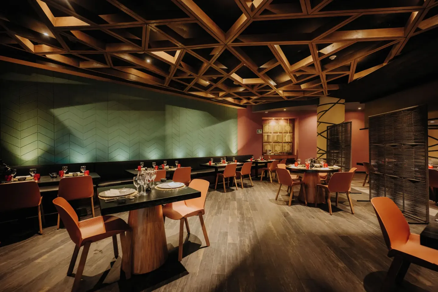 Modern restaurant dining room with orange chairs at Catalonia Playa Maroma.