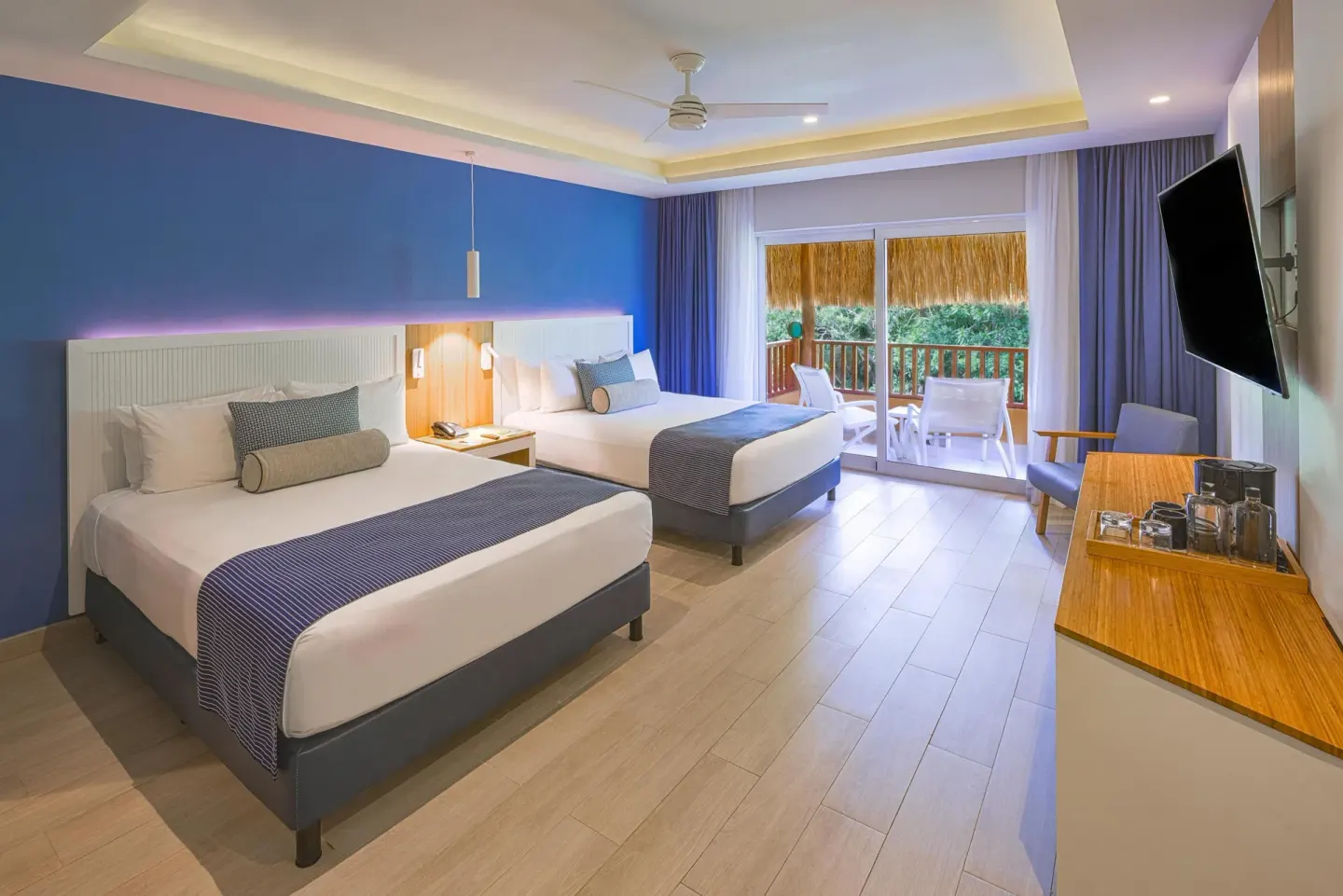 Premium Deluxe Room with two beds and balcony doors at Catalonia Playa Maroma.
