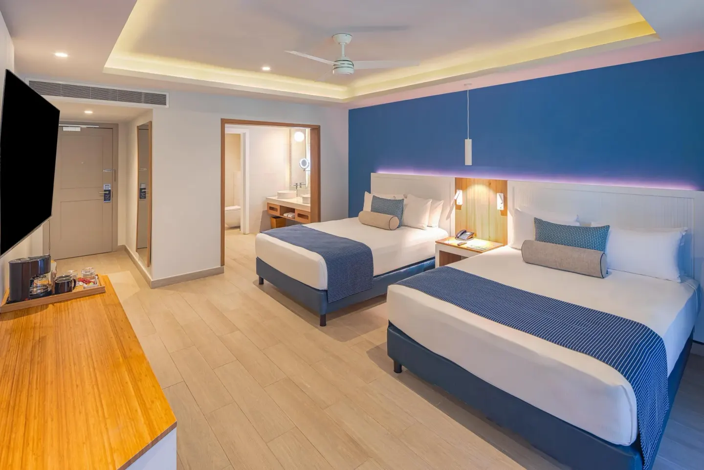 Premium Deluxe Room with two beds, TV and open bathroom at Catalonia Playa Maroma.