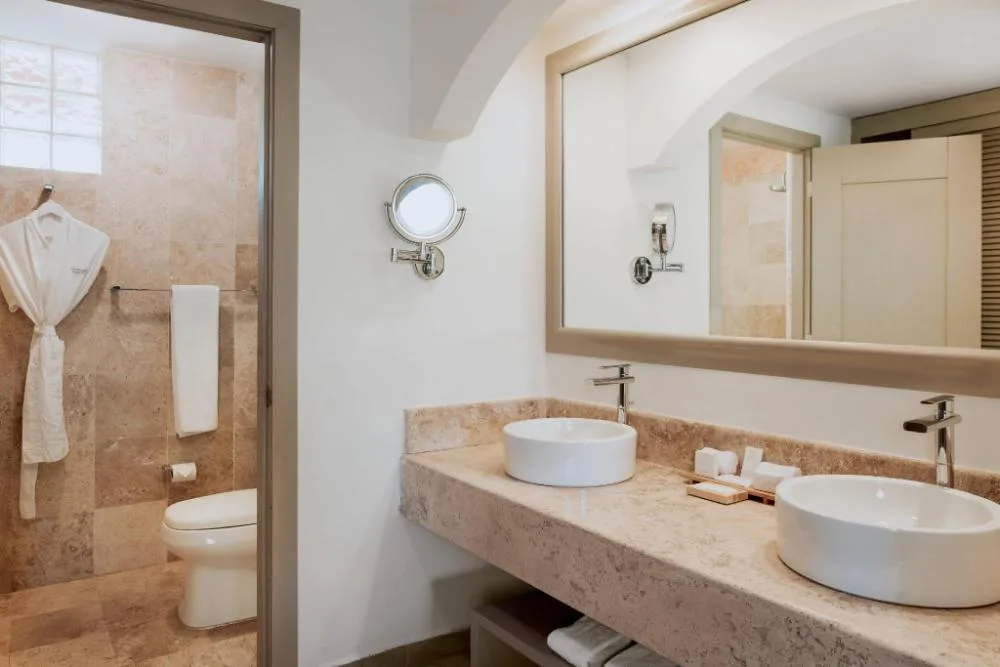 Privileged Superior Room bathroom with double sinks at Catalonia Playa Maroma.