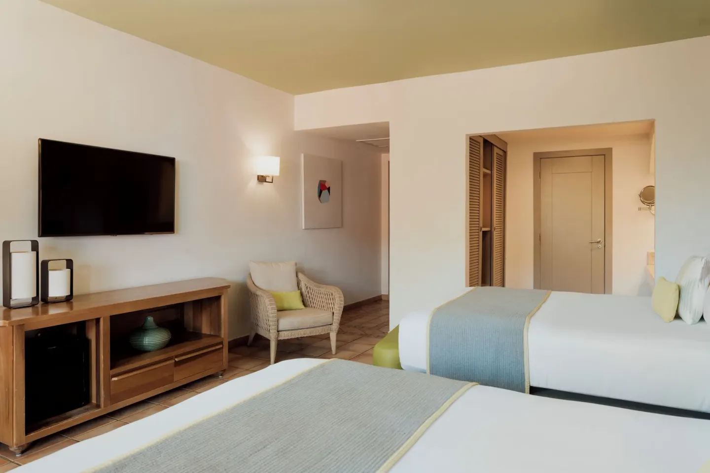 Privileged Superior room with two beds and TV console at Catalonia Playa Maroma.