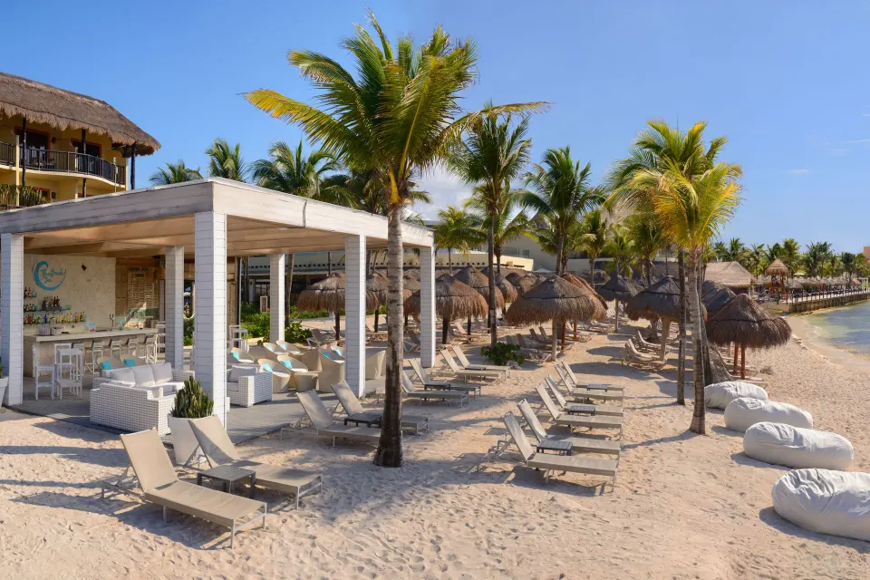 Beach loungers and seaside bar at Catalonia Riviera Maya Resort and Spa