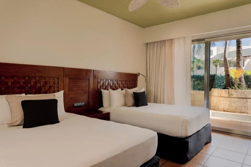 Ground-floor twin room with terrace and palm view at Catalonia Riviera Maya Resort and Spa