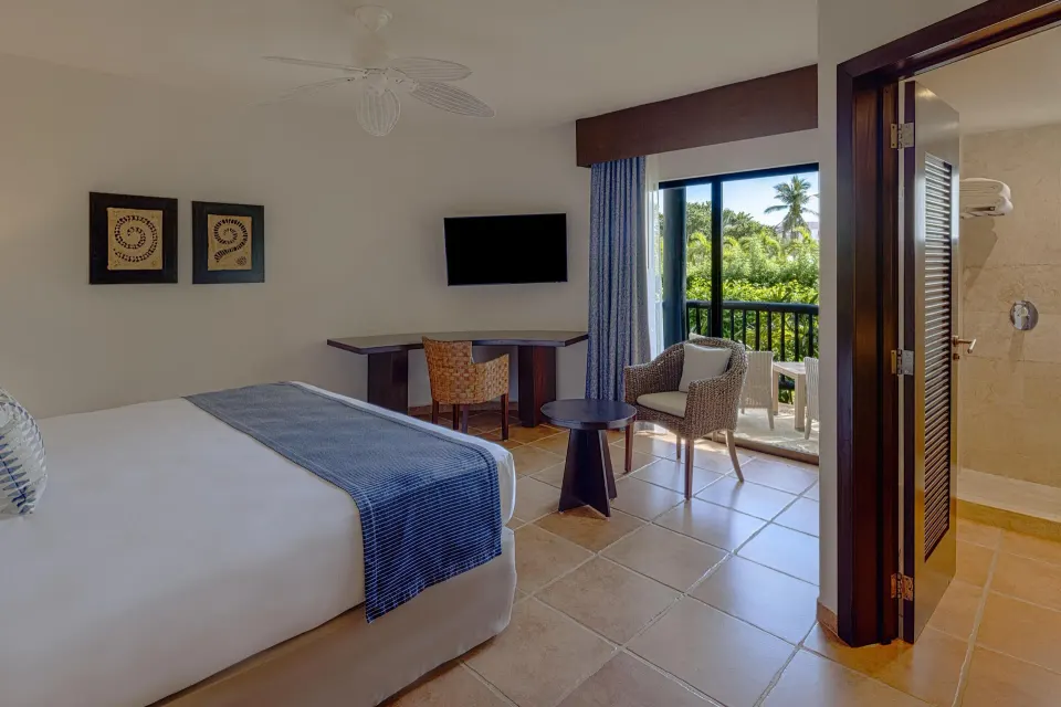 King guest room with balcony and bathroom doorway at Catalonia Riviera Maya Resort and Spa
