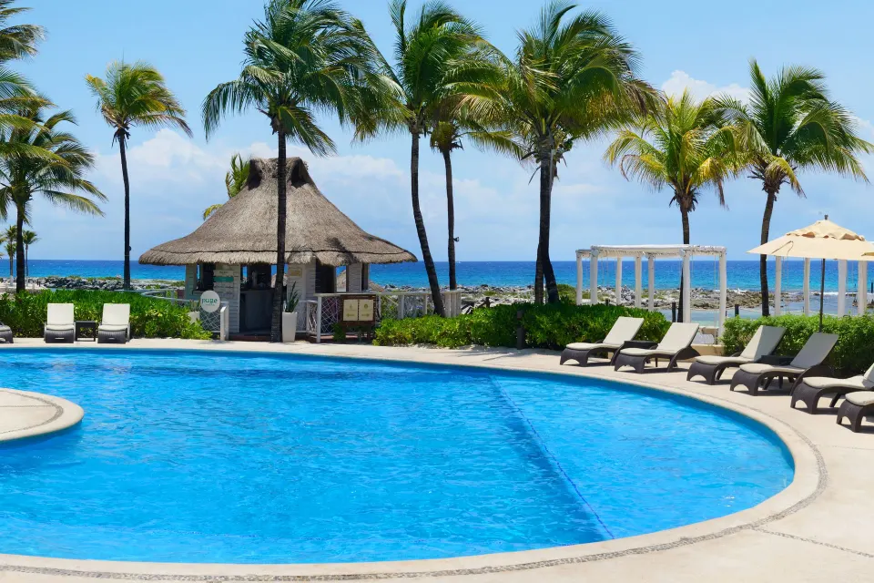Pool with ocean view and beach palapa at Catalonia Riviera Maya Resort and Spa