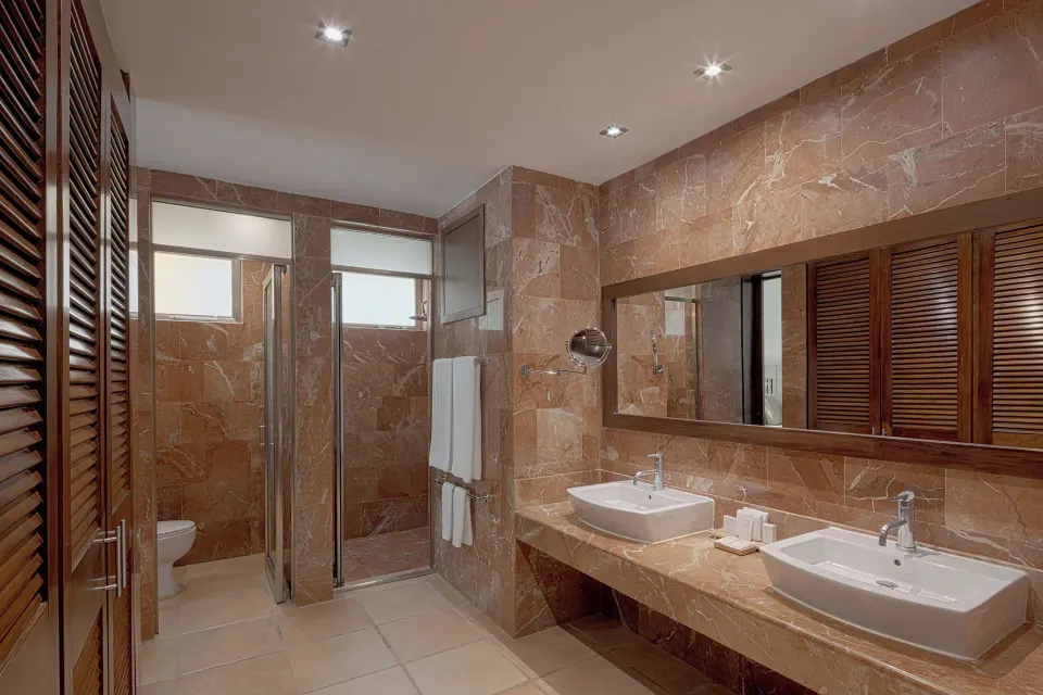 Spacious bathroom with twin sinks and marble finishes at Catalonia Riviera Maya Resort and Spa