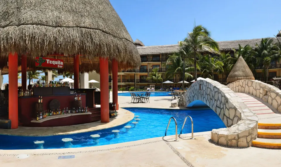 Swim-up bar and stone bridge at Catalonia Riviera Maya Resort and Spa