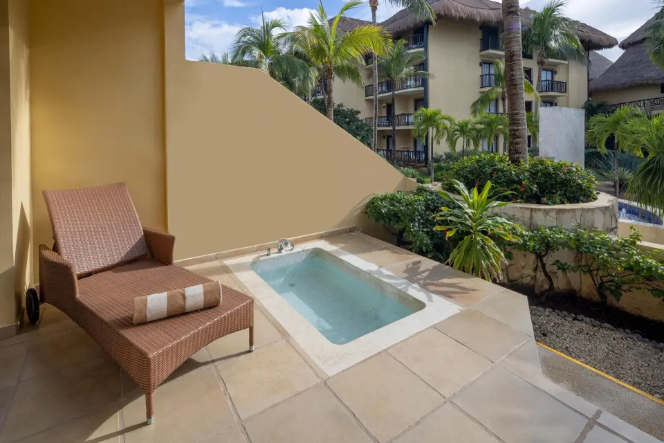 Terrace with a single lounger and small plunge pool overlooking resort landscaping at Catalonia Riviera Maya Resort and Spa