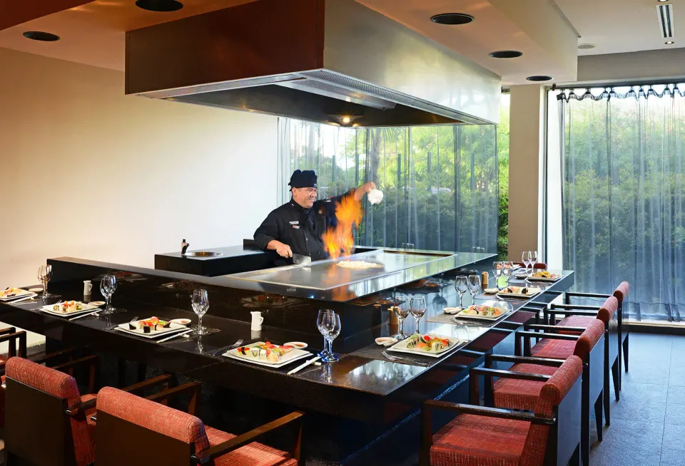 Teppanyaki chef cooking at a horseshoe counter in a private dining room at Catalonia Riviera Maya Resort and Spa