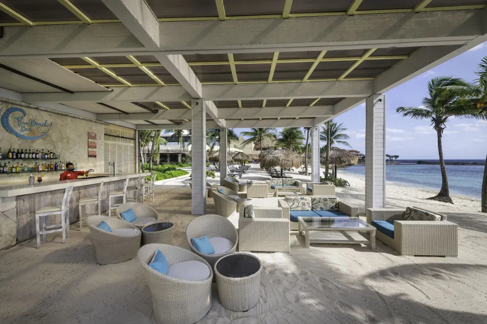 Shaded beachfront lounge and bar area on white sand at Catalonia Riviera Maya Resort and Spa
