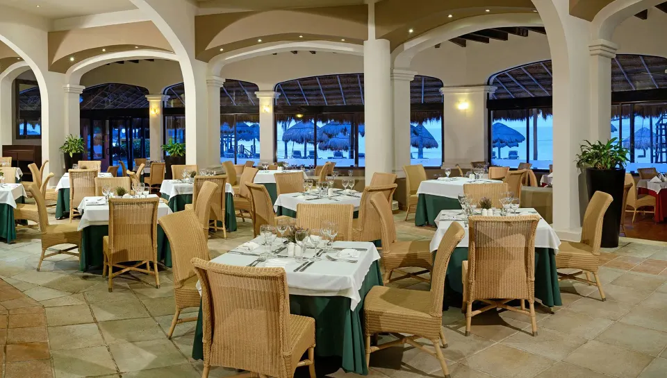 Open-air restaurant seating with sea views at Catalonia Riviera Maya Resort and Spa