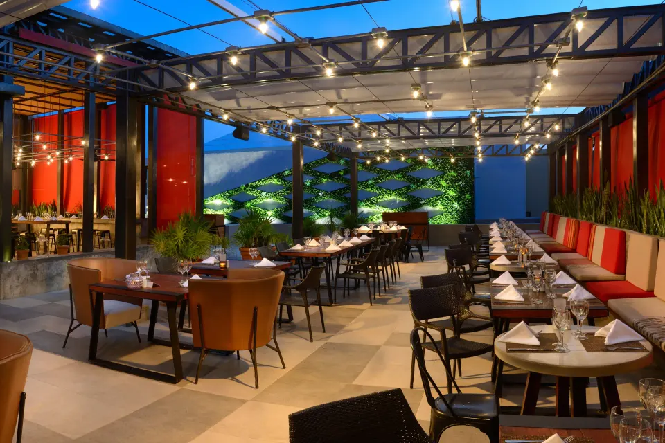 Evening terrace restaurant with string lights and outdoor seating at Catalonia Riviera Maya Resort and Spa