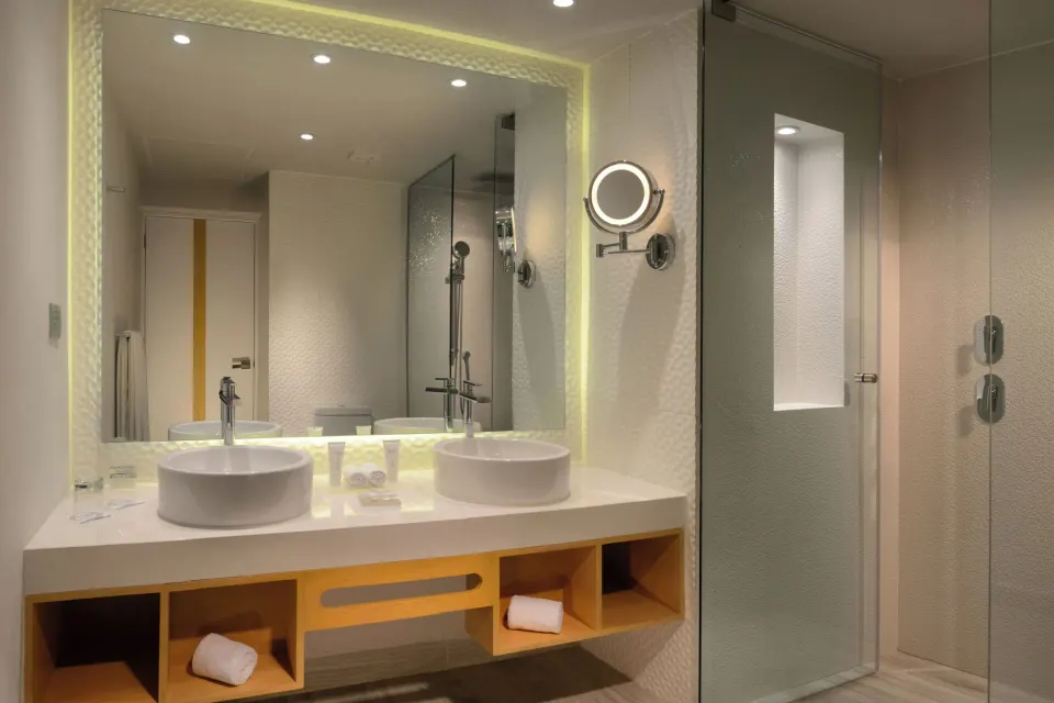 Double-sink vanity and glass shower in a Premium Deluxe Room bathroom at Catalonia Riviera Maya Resort and Spa