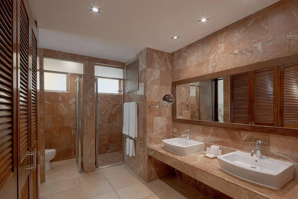 Privileged Suite bathroom double sinks and marble tile at Catalonia Riviera Maya Resort and Spa