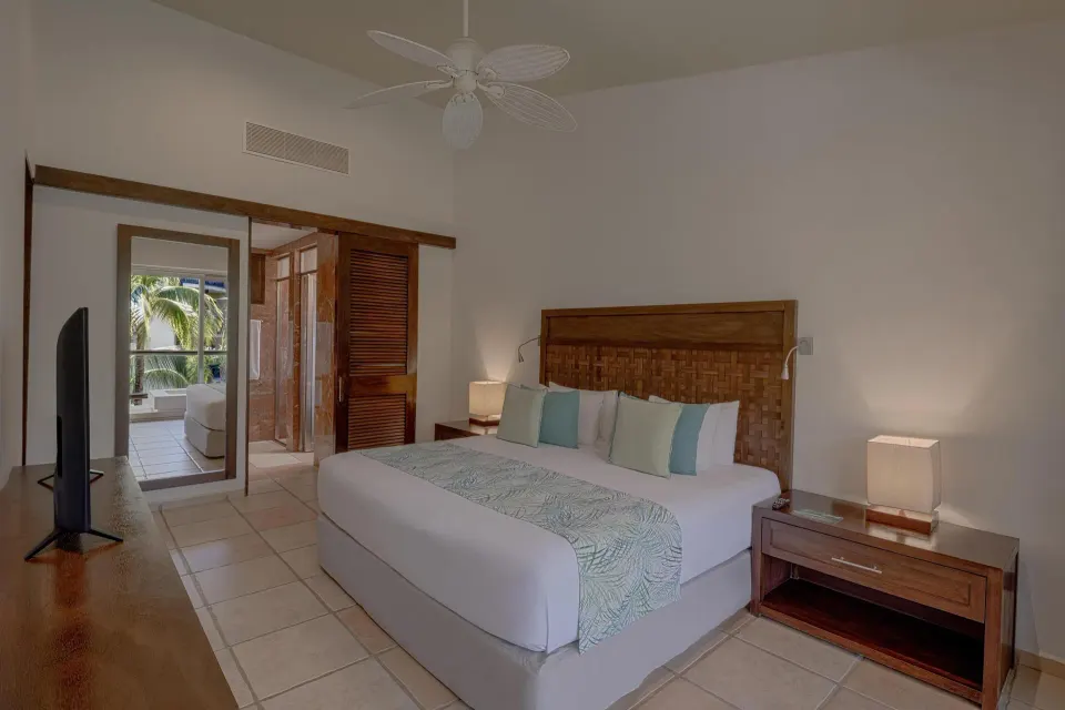 Privileged Suite king bed from doorway with TV and balcony at Catalonia Riviera Maya Resort and Spa