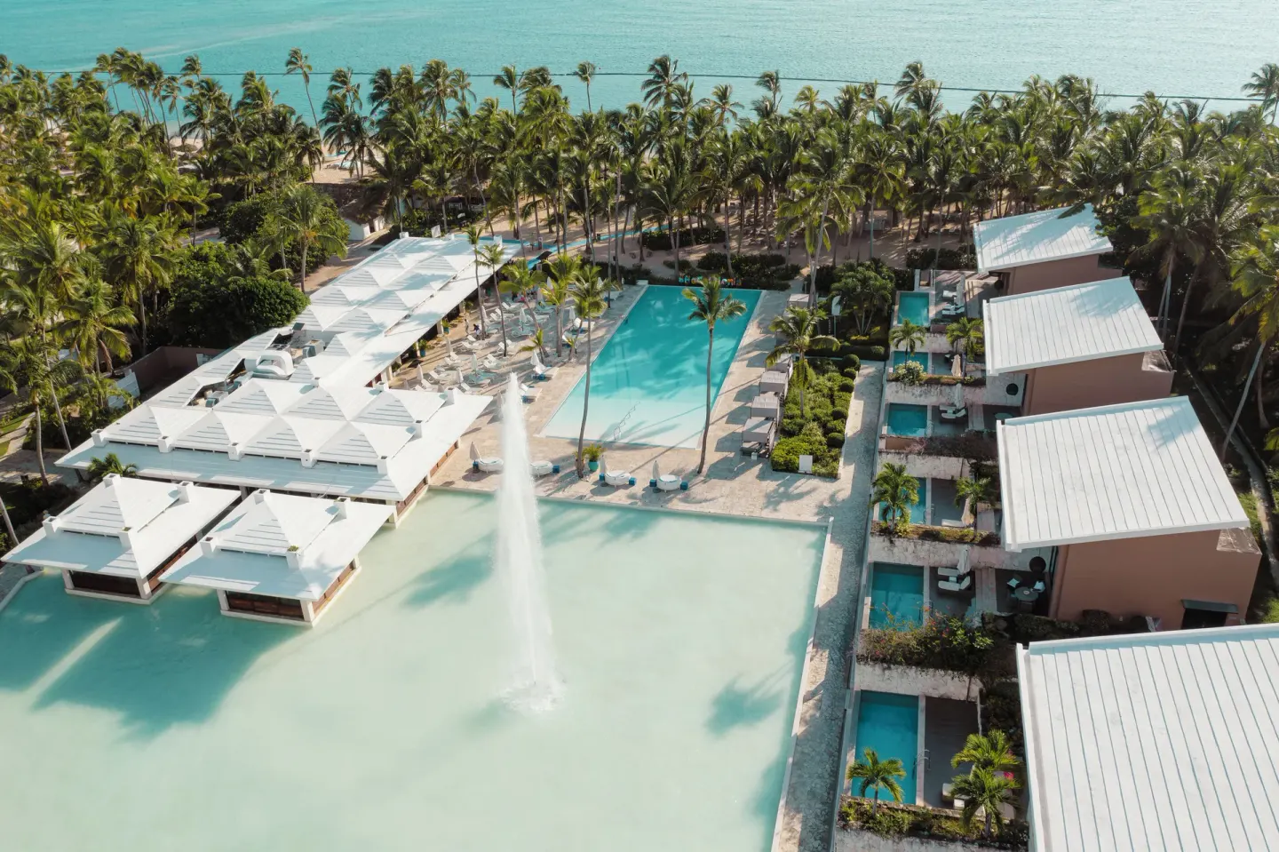 Aerial view of pools, palms and resort buildings at Catalonia Royal Bavaro.