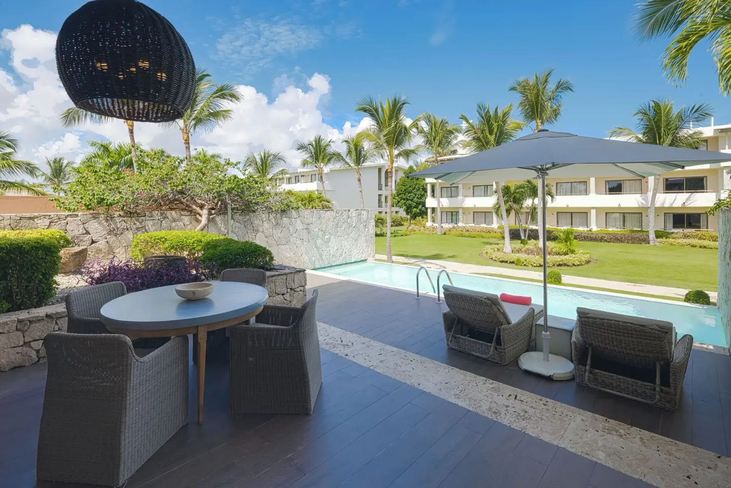 Covered terrace seating beside a narrow pool at Catalonia Royal Bavaro.