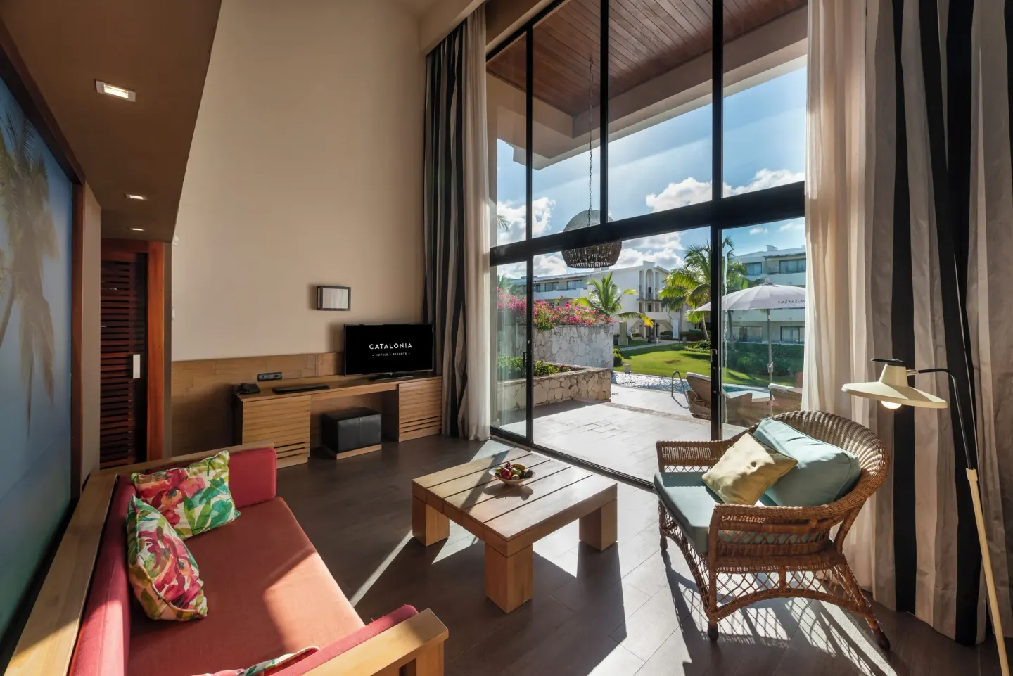 Guest room sitting area with terrace and garden view at Catalonia Royal Bavaro.