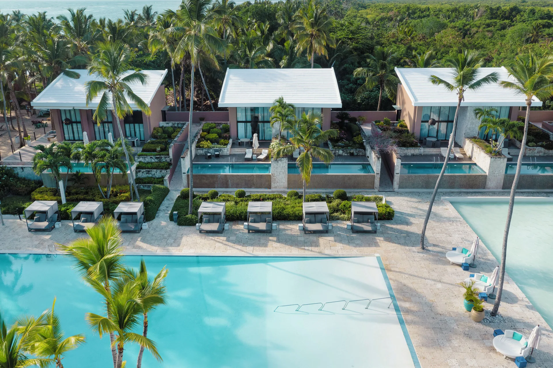 Aerial view of poolside villas and palm trees at Catalonia Royal Bavaro.